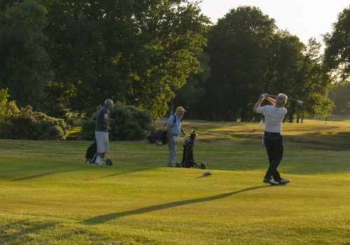 golfer taking a swing on the fairway
