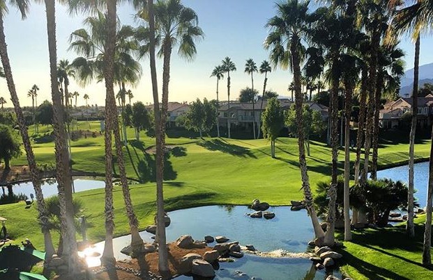 view of golf course with palm trees