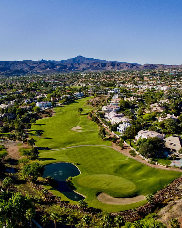 Aerial view of golf course with pond
