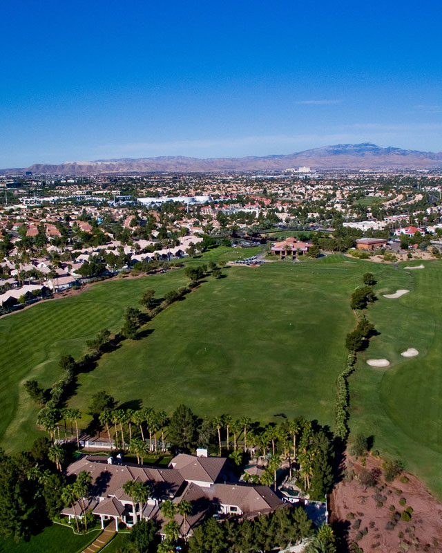 View of golf course from above with clubhouse