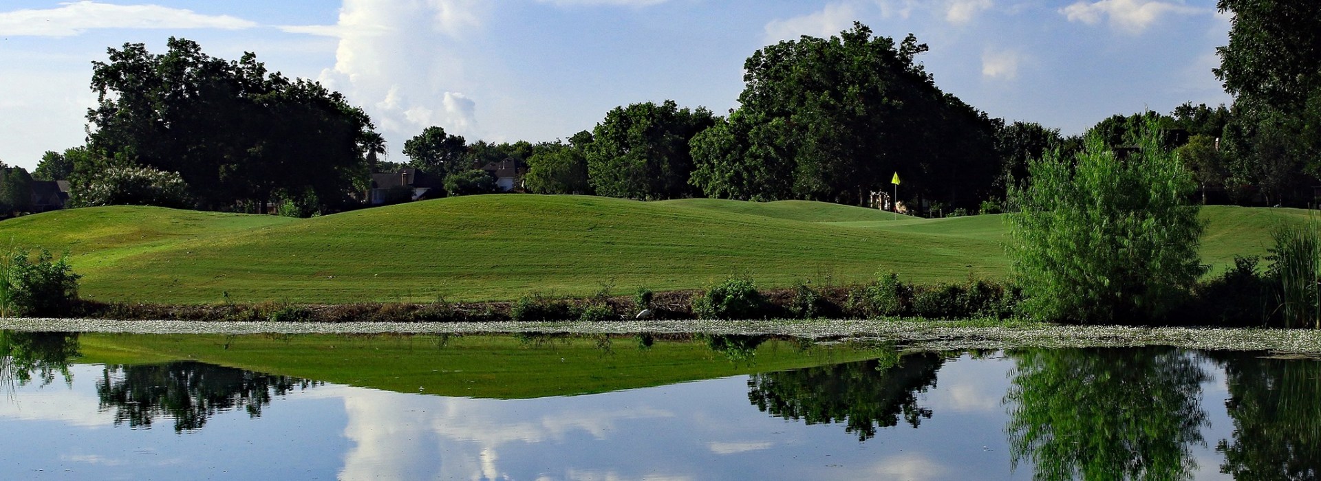 Golf course with pond in foreground