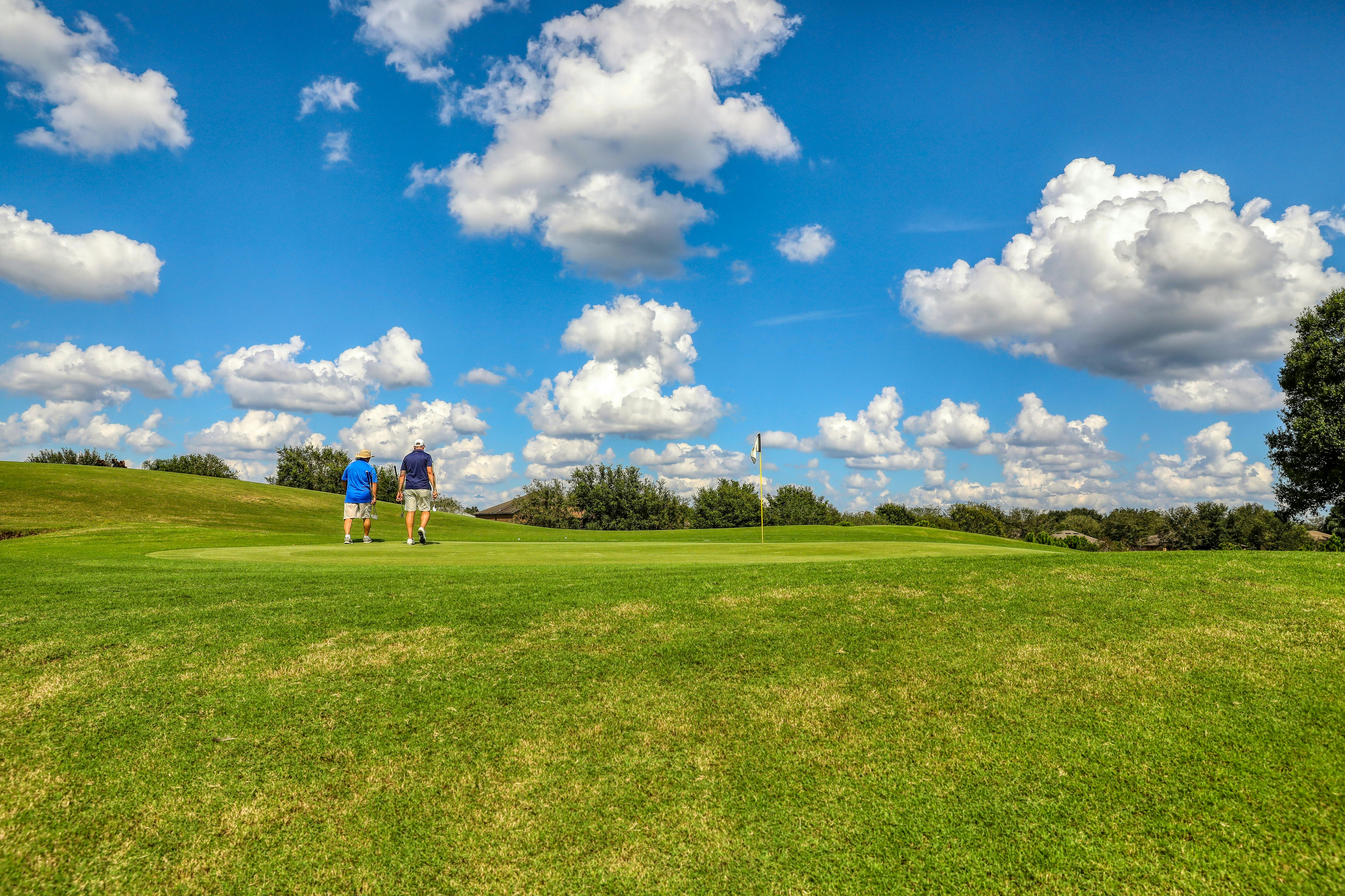 Golf course green with clouds in the sky