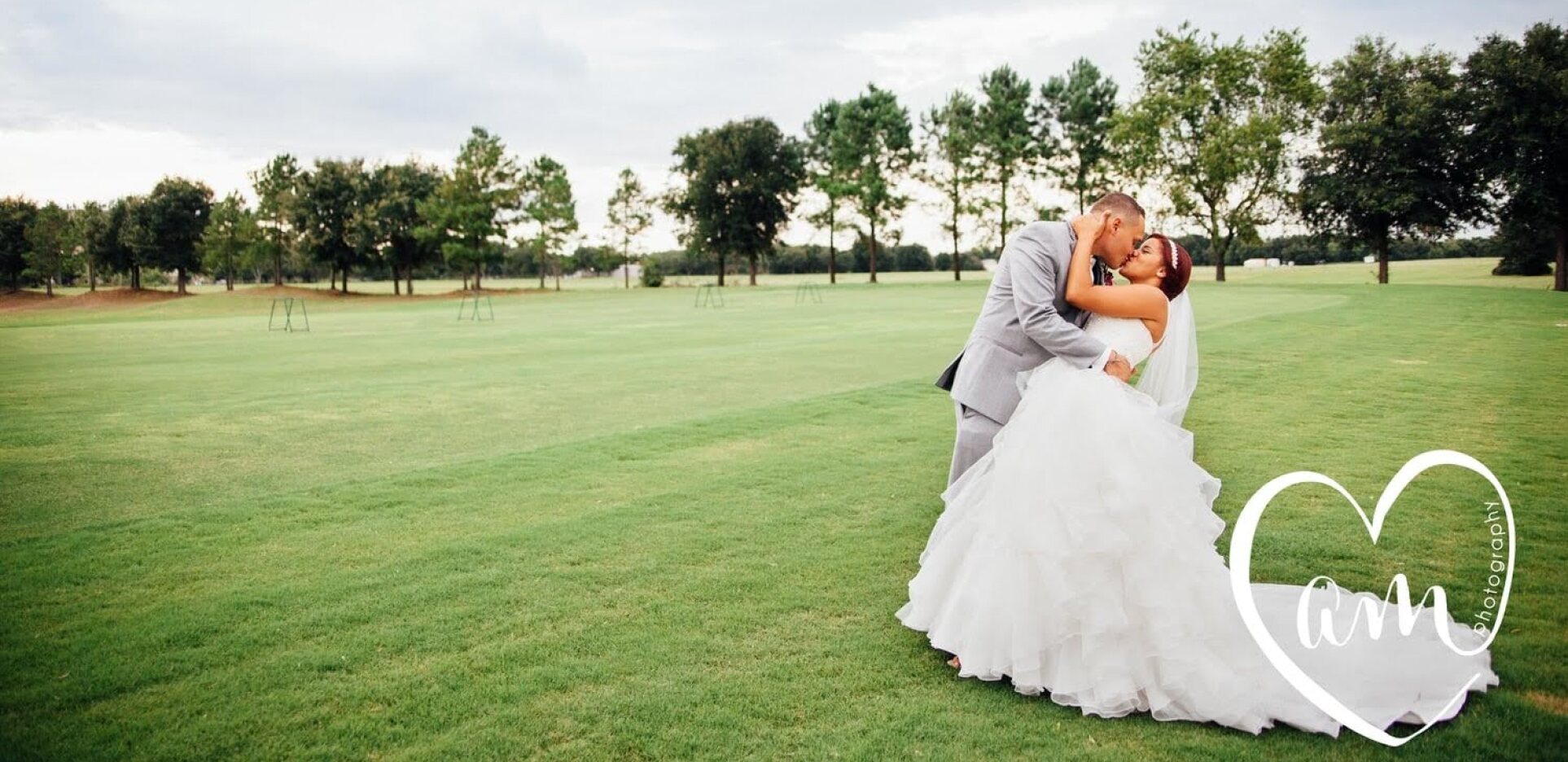 Bride and groom embracing on golf course