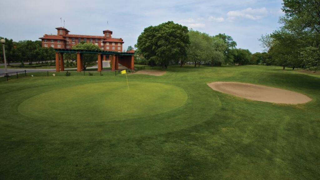 Bunker on golf course with clubhouse in distance