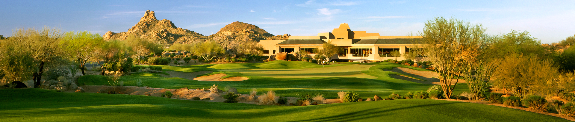 Troon North Golf Arizona facilities during the golden hour seen from the nearby green.