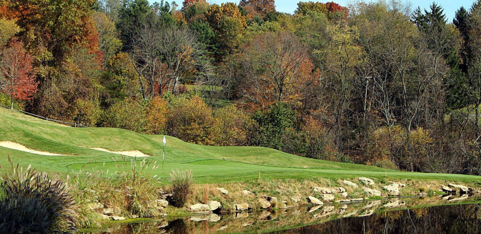 Golf course with autumn trees in background