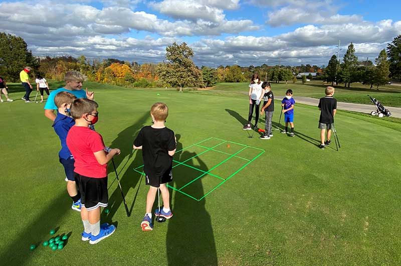 Junior golfers practicing on golf course